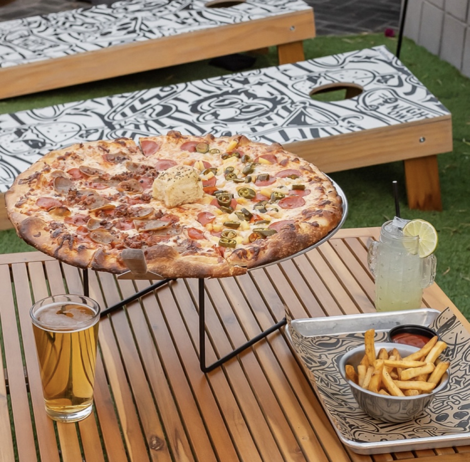 Pizza, pints + zebra cornhole